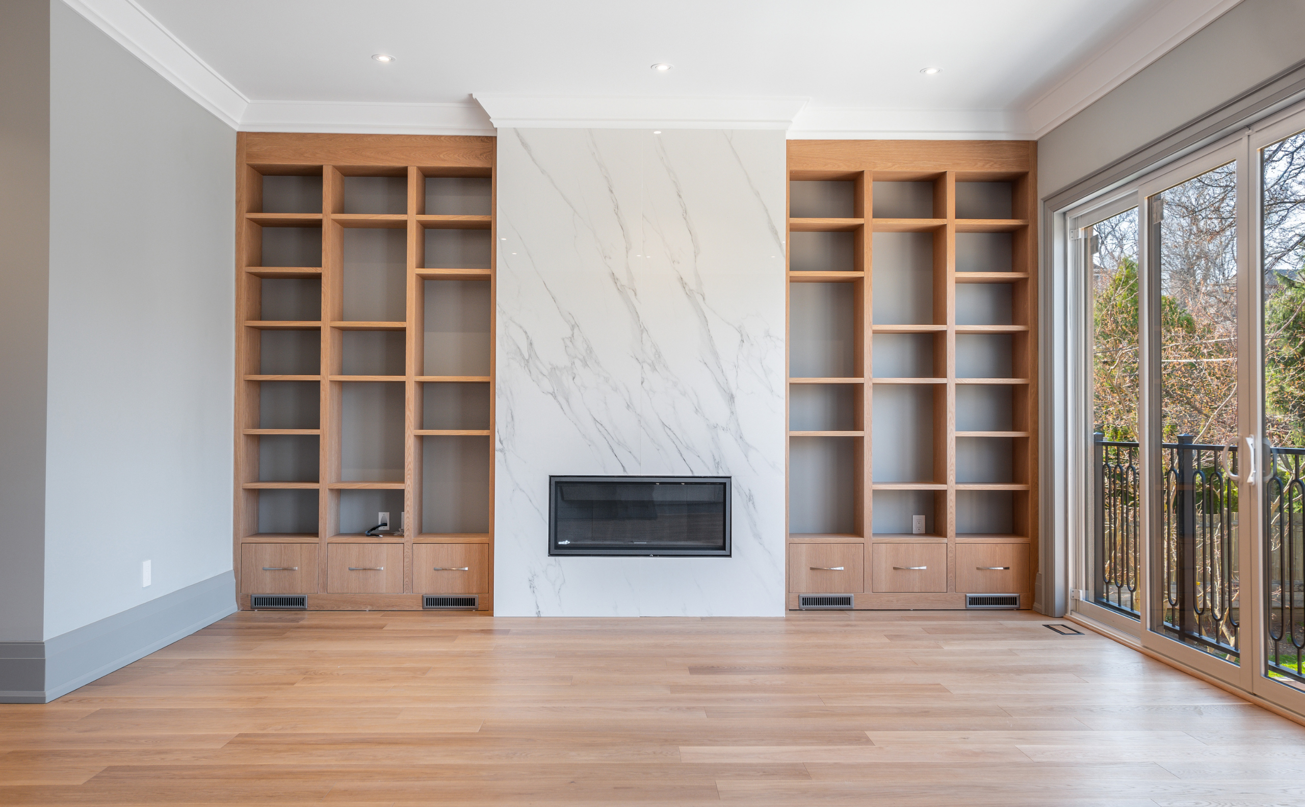 Open shelves by the fireplace with fine cabinetry