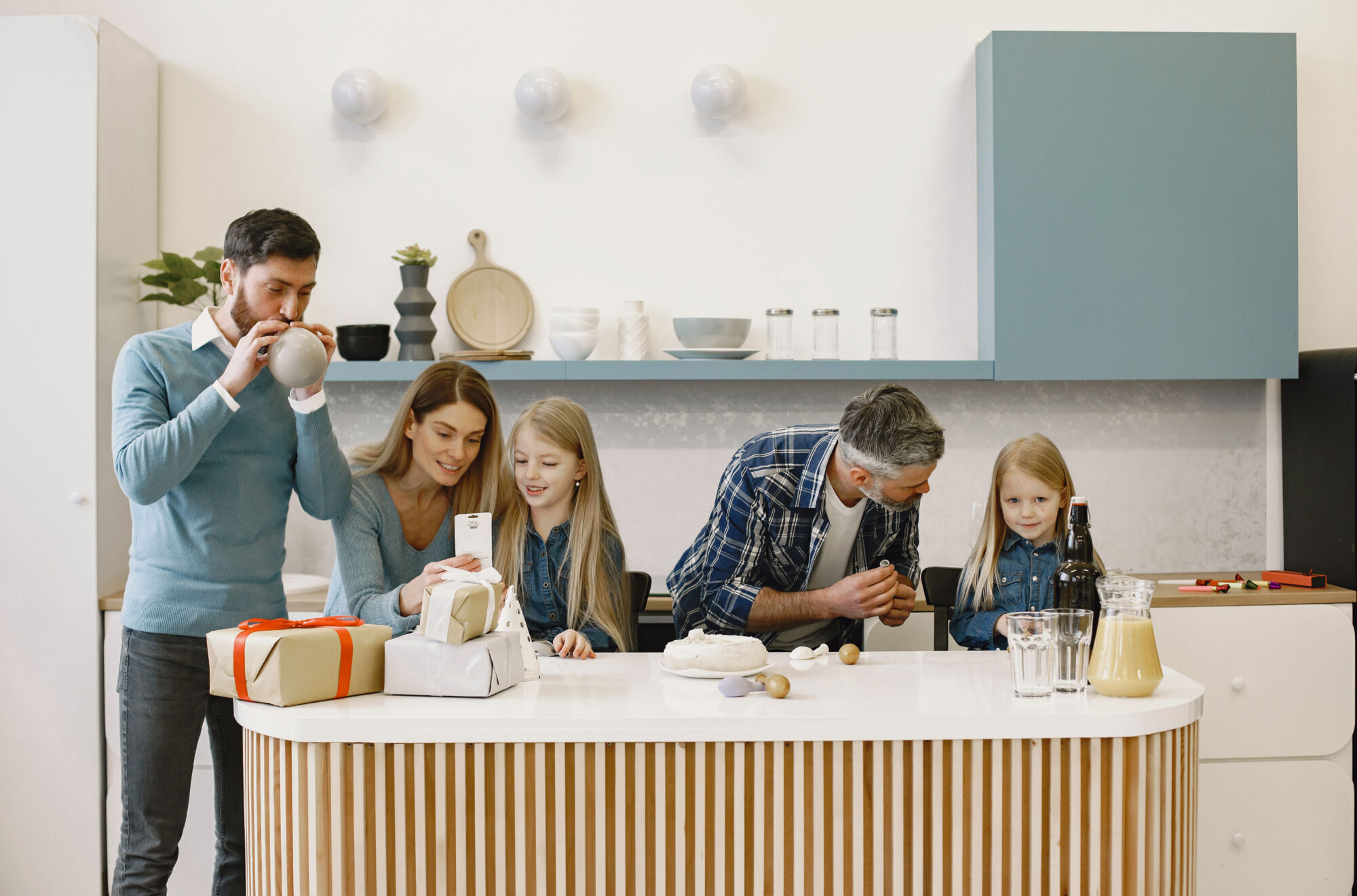 Family gathered around the kitchen island with presents