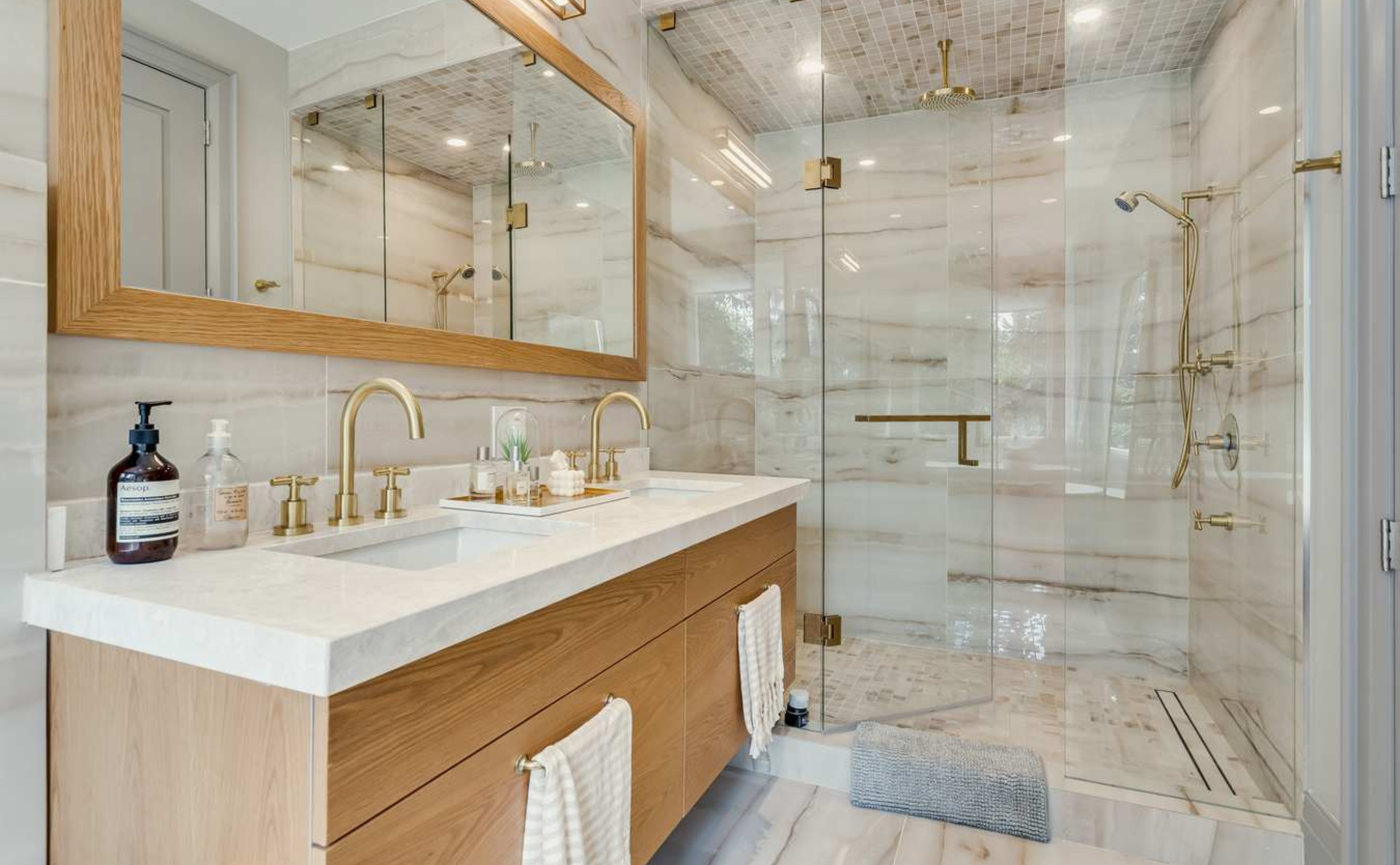 Bathroom Renovation side view showing all 4pcs, designed with wooden cabinetry, marble finishing and gold hardware details